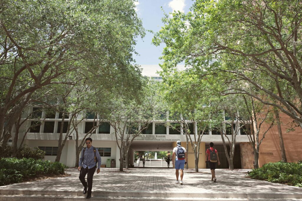 Students walking through a sunlit university campus in Coral Gables, Florida.
